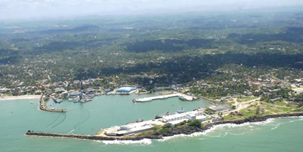 Aerial close up view of port with yachts in the sea near the beach,